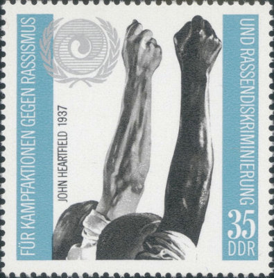 Item no. S14 (stamp)
Type: stamp
Country: DDR (German Democratic Republic)
Date of issue: 23 September 1971
Catalog number: Michel 1702
Stamp issued to honor Intl. Year Against Racism. Single stamp. Its design is based on the John HEARTFIELD’s photograph of 1937 Raised arms .
Item_no._s14__stamp_.jpg